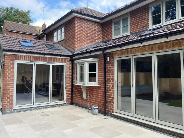 Rear extension with sliding patio doors and a large paved terrace